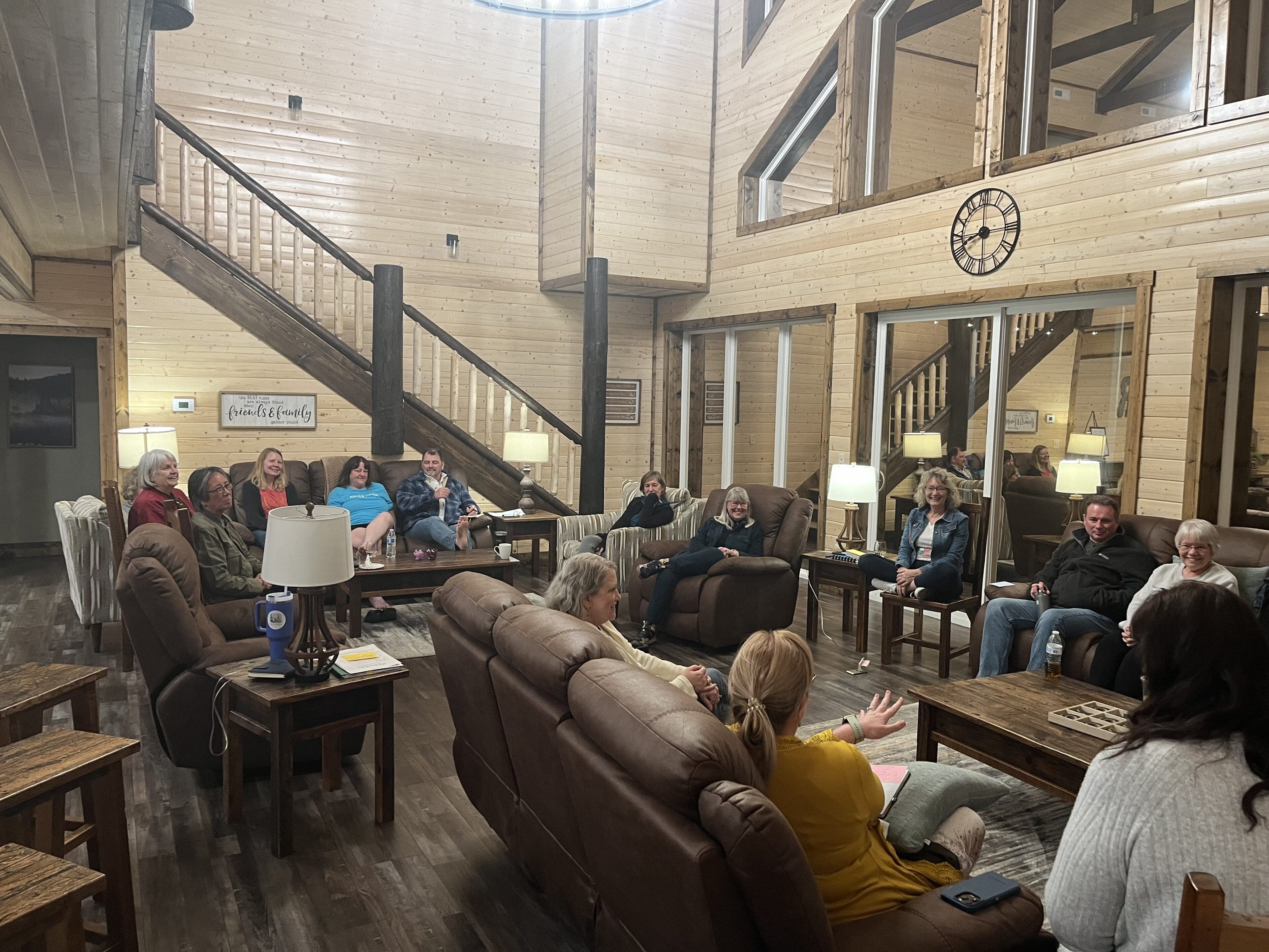 A group of people sitting in a room with tables.