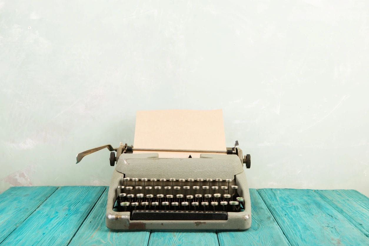 A typewriter with paper on top of it.